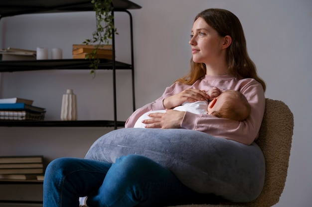 Side view mother with cute newborn