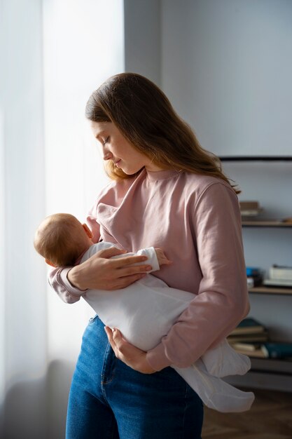 Side view mother with cute newborn