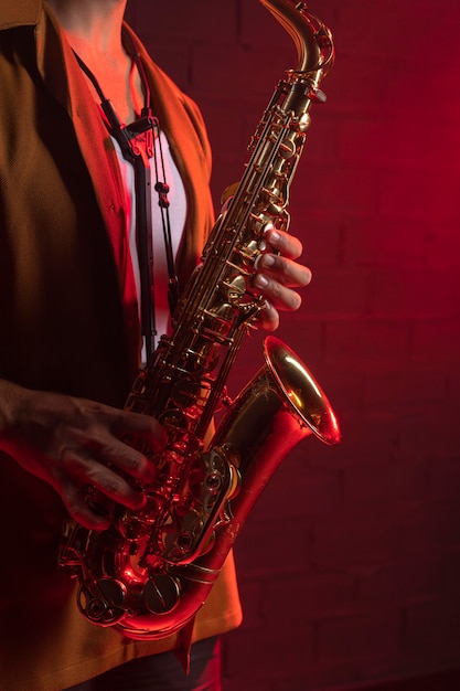 Free Photo side view of musician playing the saxophone