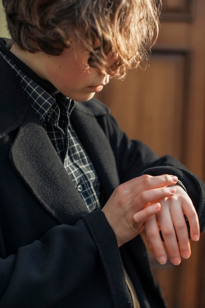 Side view non binary person looking at the watch