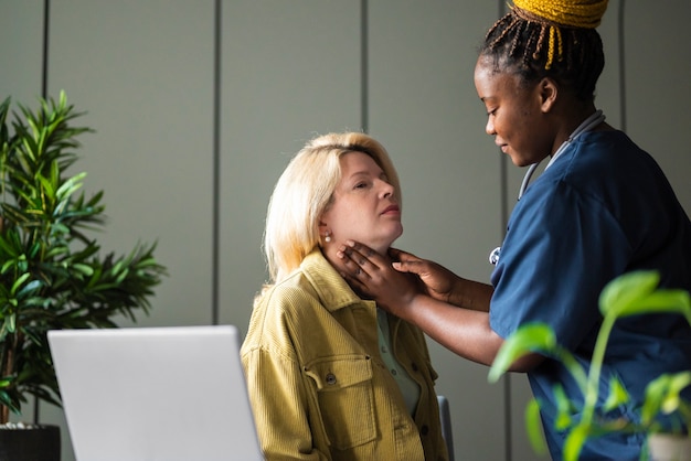 Free Photo side view nurse checking patient