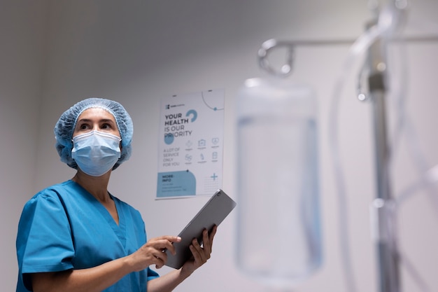 Side view nurse holding tablet