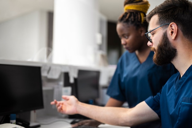 Free Photo side view nurses working together