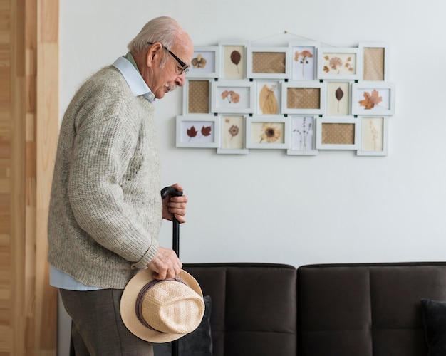 Free photo side view of old man in a nursing home