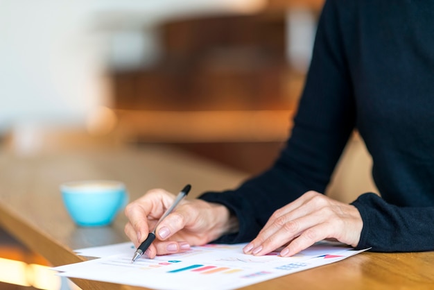 Side view of older business woman working with papers