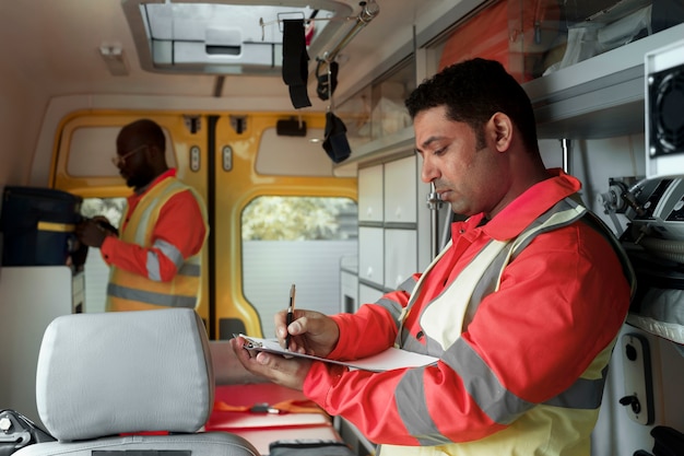 Free Photo side view paramedic filling document