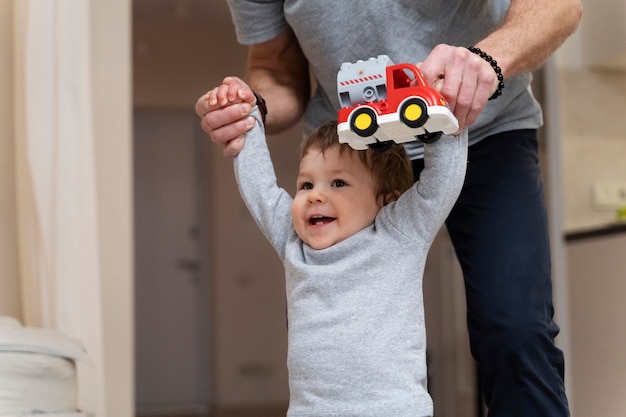 Free photo side view parent holding kid's hands