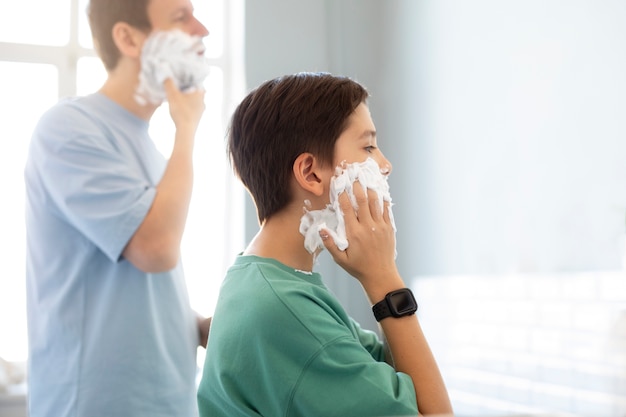 Side view people applying shaving cream