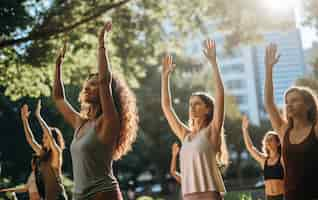 Free photo side view people doing yoga together