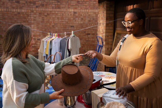 Side view people at garage sale