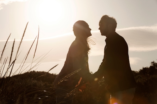 Side view people holding hands outdoors