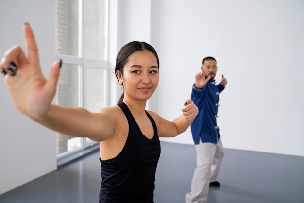 Side view people practicing tai chi