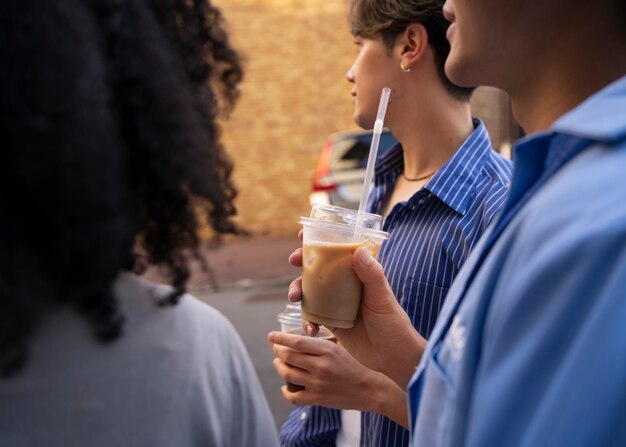 Side view people with iced coffee