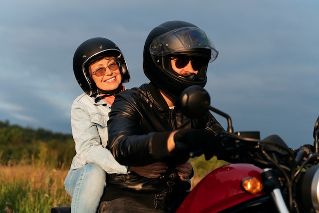 Side view people with motorbike outdoors