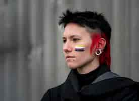 Free photo side view person having a non binary flag painted on the cheek