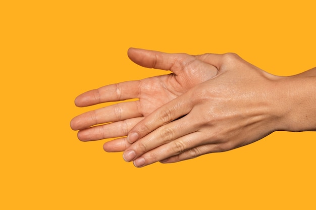 Side view person washing hands isolated on orange