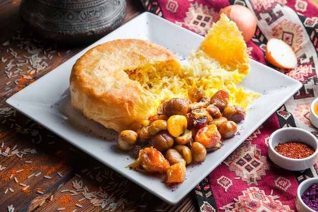 Side view pilaf in a pita with chestnut, dried apricots, cherry plum. traditional oriental dish on a dark wooden surface horizontal