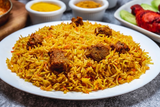 Side view pilaf with stewed beef meat on a plate