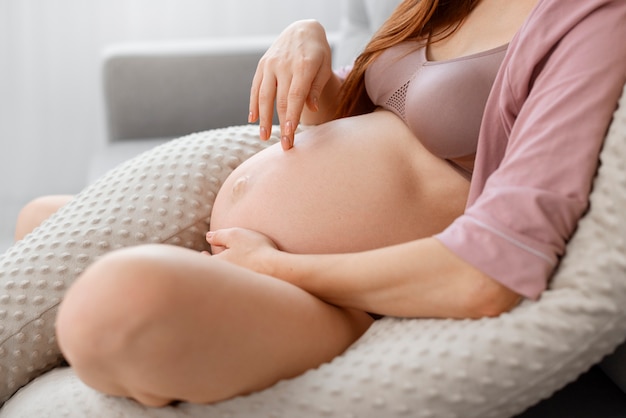 Side view pregnant woman on nursing pillow