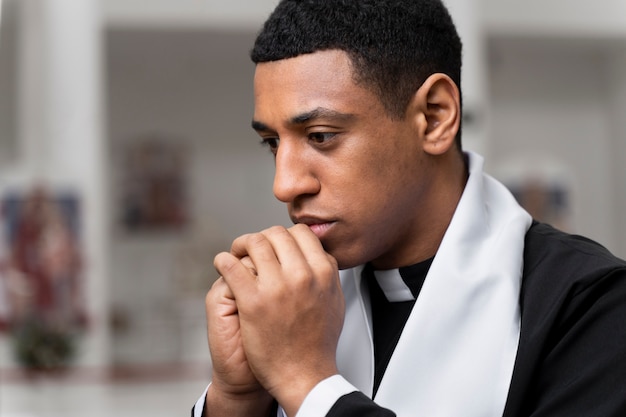 Side view priest praying at church