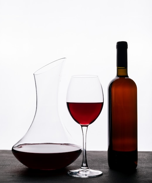 Free photo side view red wine with glass on white vertical