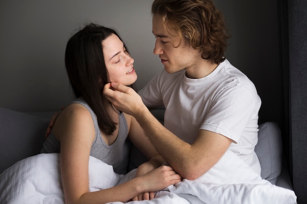 Side view of romantic couple in bed