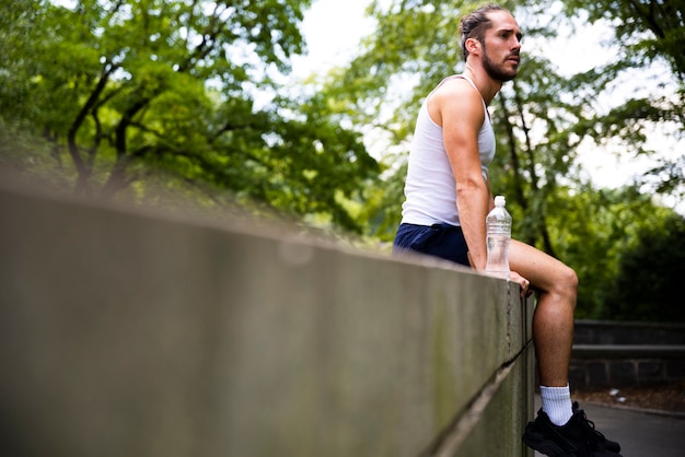 Side view of runner taking a break