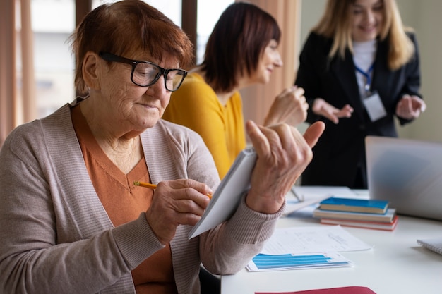 Free Photo side view senior people learning together