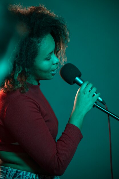 Side view singer working in a studio