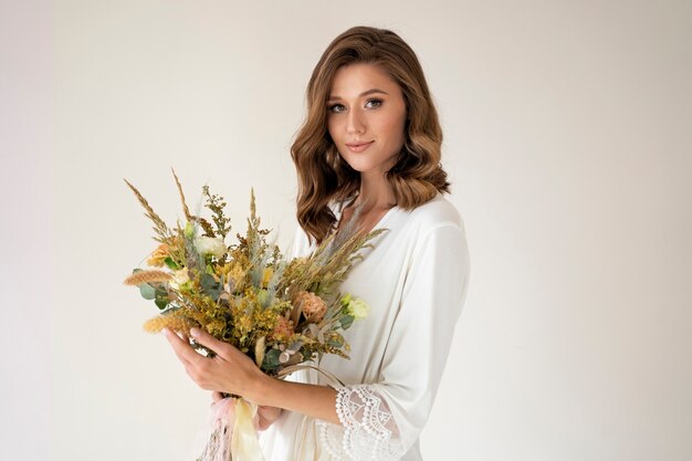 Side view smiley bride holding flowers