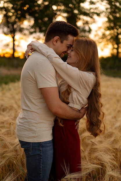 Side view smiley couple hugging