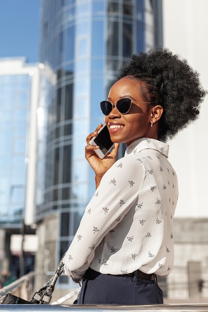 Side view smiley female with phone