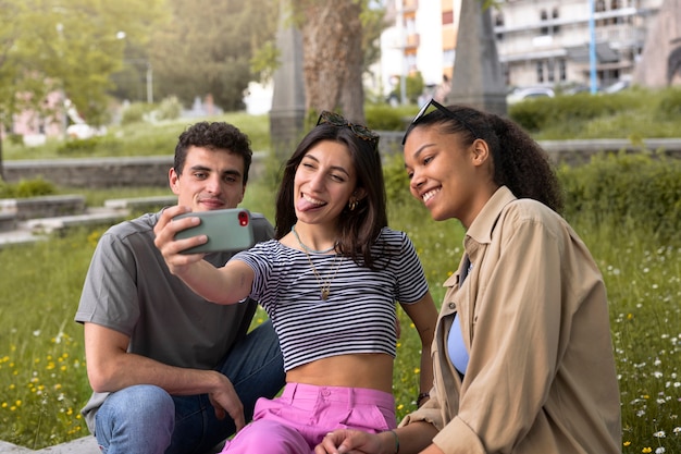 Side view smiley friends taking selfie