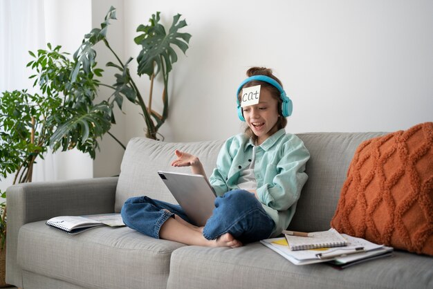 Side view smiley girl holding tablet