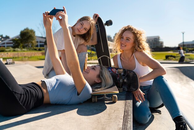 Side view smiley girls taking selfie