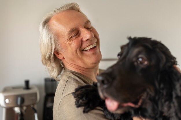 Side view smiley man holding dog