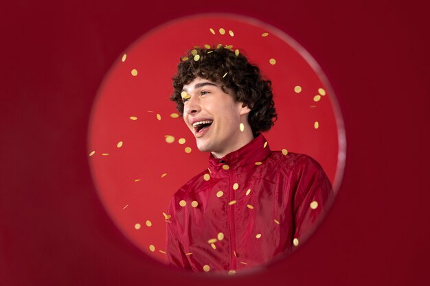 Side view smiley man posing with confetti