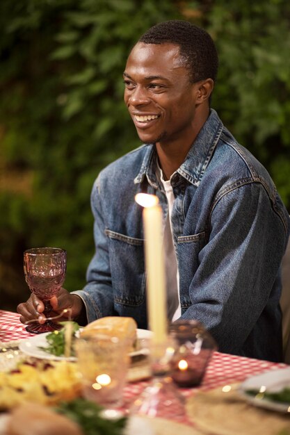 Side view smiley man sitting at table