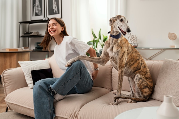 Free Photo side view smiley woman and dog