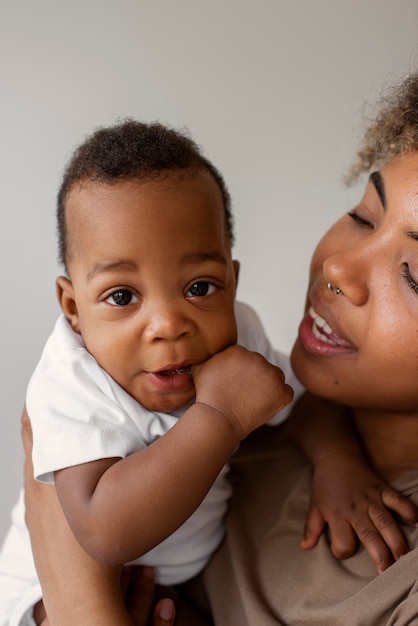 Side view smiley woman holding baby