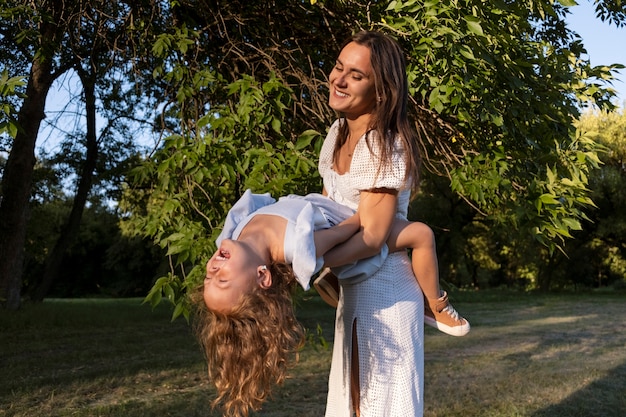 Side view smiley woman holding girl