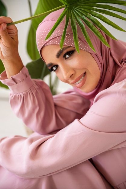 Side view smiley woman holding green leaf