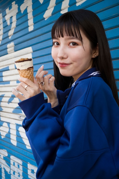 Free Photo side view smiley woman holding ice cream cone