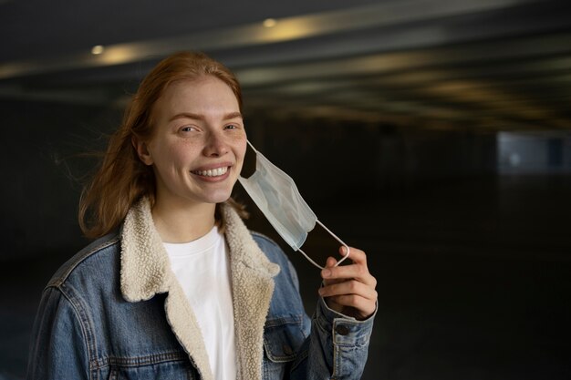 Side view smiley woman mask free