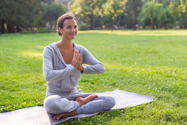 Side view smiley woman meditating pose