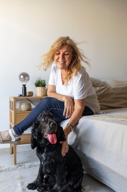 Free Photo side view smiley woman petting dog