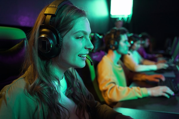 Free Photo side view smiley woman playing videogame