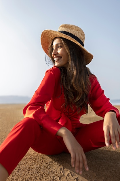 Side view smiley woman posing in desert