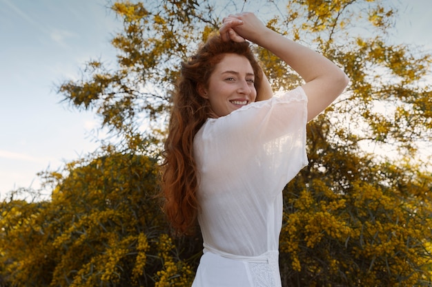 Free Photo side view smiley woman posing outdoors