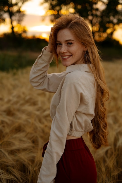 Side view smiley woman posing outdoors